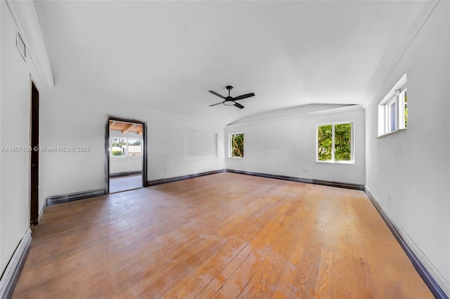 5757 Alton Rd, Miami Beach, FL 33140 - unfurnished room with healthy amount of natural light, lofted ceiling, baseboard heating, ceiling fan, and light wood-style floors
