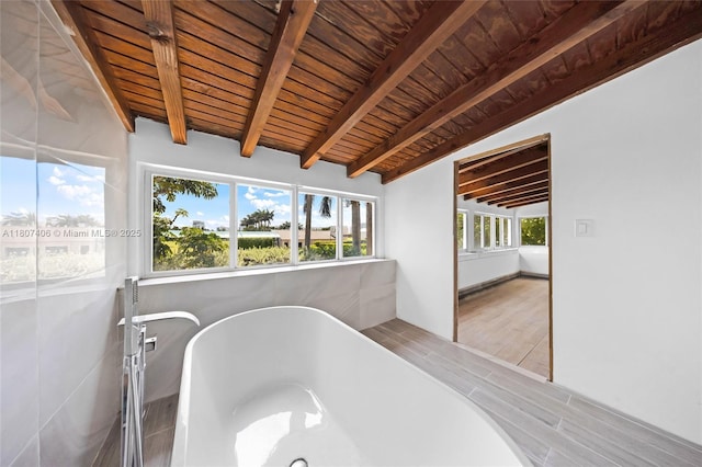 5757 Alton Rd, Miami Beach, FL 33140 - bathroom featuring wooden ceiling with exposed beams, a soaking tub, and wood finished floors