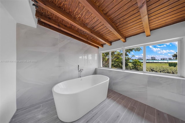 5757 Alton Rd, Miami Beach, FL 33140 - bathroom featuring tile walls, a freestanding tub, wood finish floors, and wood ceiling