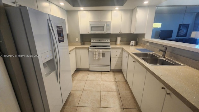 17375 Collins Ave Unit 2606, Sunny Isles Beach, FL 33160 - kitchen with white appliances, a sink, white cabinetry, light tile patterned floors, and light countertops