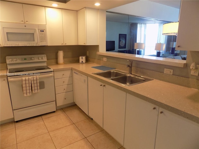 17375 Collins Ave Unit 2606, Sunny Isles Beach, FL 33160 - kitchen with white appliances, a sink, white cabinetry, light countertops, and recessed lighting