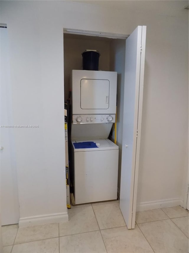 17375 Collins Ave Unit 2606, Sunny Isles Beach, FL 33160 - washroom with stacked washer / dryer, tile patterned flooring, and baseboards