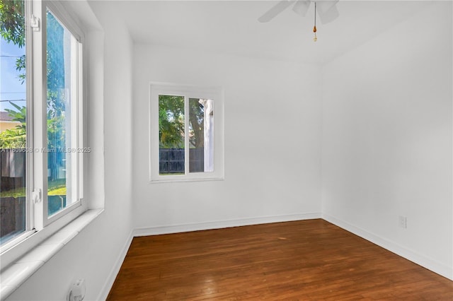 152 NW 103rd St, Miami Shores, FL 33150 - spare room featuring healthy amount of natural light, wood finished floors, a ceiling fan, and baseboards