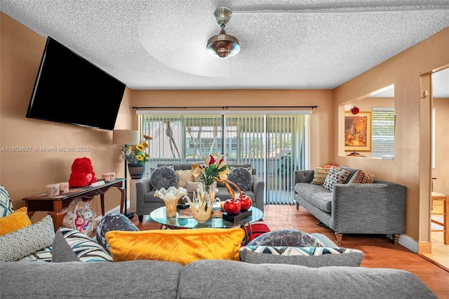 203 E Capri Unit E, Delray Beach, FL 33484 - living area with wood finished floors, a textured ceiling, and baseboards