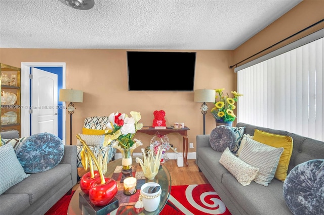 203 E Capri Unit E, Delray Beach, FL 33484 - living area featuring a textured ceiling and wood finished floors