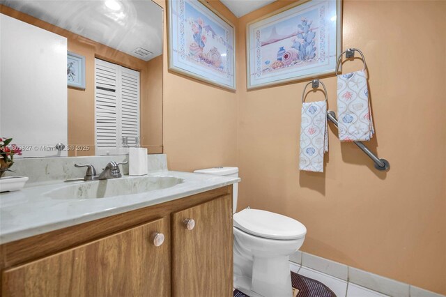 203 E Capri Unit E, Delray Beach, FL 33484 - bathroom with tile patterned flooring, vanity, toilet, and baseboards