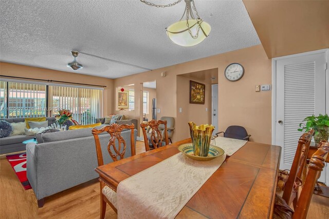 203 E Capri Unit E, Delray Beach, FL 33484 - dining room featuring a textured ceiling and light wood-type flooring