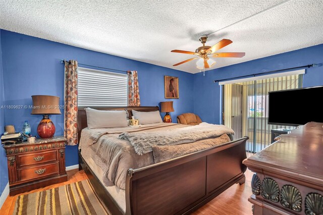 203 E Capri Unit E, Delray Beach, FL 33484 - bedroom with wood finished floors, a textured ceiling, a ceiling fan, and access to outside