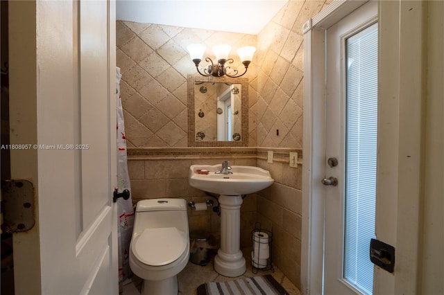 45 NW 188th St, Miami Gardens, FL 33169 - bathroom featuring tile walls, toilet, and a chandelier