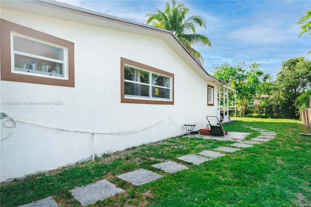 45 NW 188th St, Miami Gardens, FL 33169 - view of side of home with a lawn and stucco siding