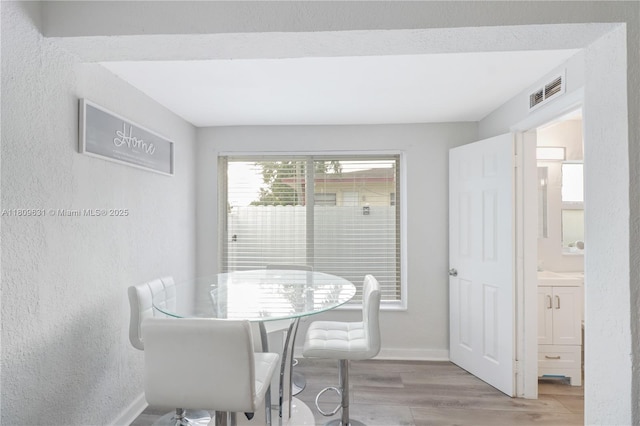 6039 SW 38th St, Miramar, FL 33023 - dining area featuring light wood-style flooring and a textured wall