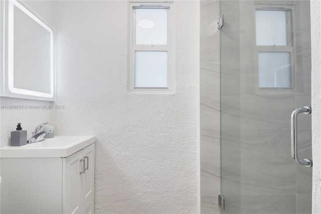 6039 SW 38th St, Miramar, FL 33023 - bathroom featuring vanity, a shower stall, and a textured wall