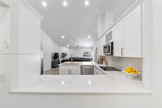 4647 NW 98th Ln, Coral Springs, FL 33076 - kitchen with stainless steel appliances, a peninsula, open floor plan, recessed lighting, and light stone countertops