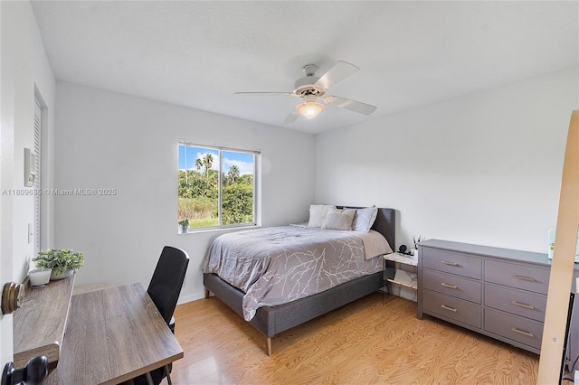 4647 NW 98th Ln, Coral Springs, FL 33076 - bedroom with light wood finished floors and a ceiling fan