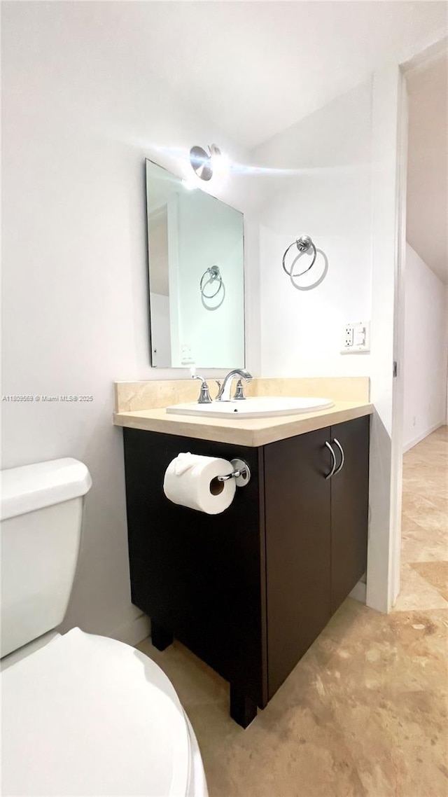 3025 Mary St Unit 5, Miami, FL 33133 - half bathroom with toilet, vanity, and vaulted ceiling