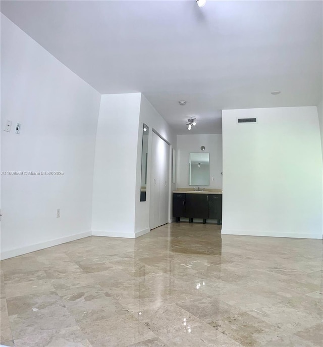 3025 Mary St Unit 5, Miami, FL 33133 - spare room with a sink, baseboards, and light marble finish flooring