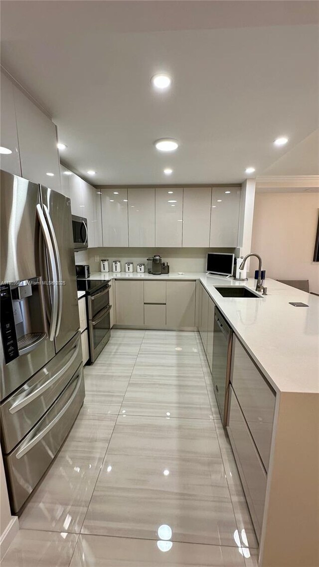 1865 S Ocean Dr Unit 19N, Hallandale Beach, FL 33009 - kitchen featuring stainless steel appliances, modern cabinets, a sink, gray cabinets, and a peninsula