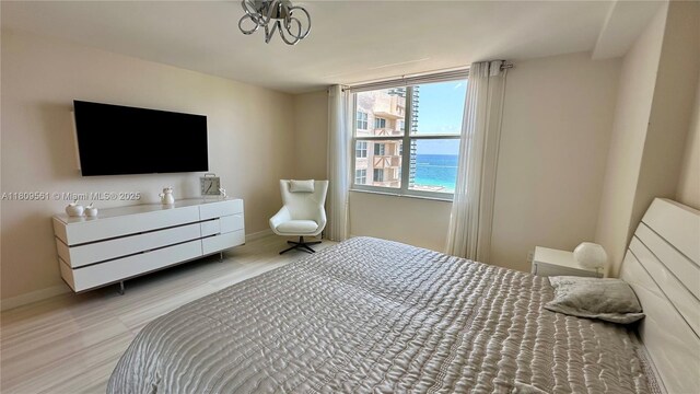1865 S Ocean Dr Unit 19N, Hallandale Beach, FL 33009 - bedroom with baseboards, wood finished floors, and a chandelier