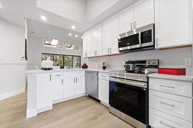 7932 Seville Pl Unit 2104, Boca Raton, FL 33433 - kitchen featuring stainless steel appliances, light countertops, a peninsula, white cabinetry, and recessed lighting