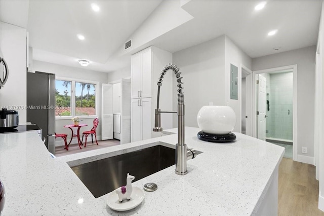 7932 Seville Pl Unit 2104, Boca Raton, FL 33433 - kitchen featuring white cabinetry, light stone countertops, electric panel, freestanding refrigerator, and recessed lighting