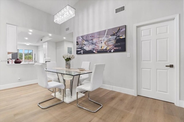 7932 Seville Pl Unit 2104, Boca Raton, FL 33433 - dining space featuring baseboards, wood finished floors, and a towering ceiling
