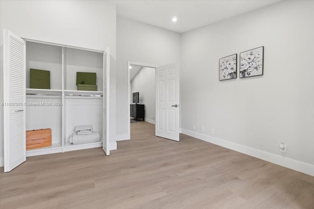 7932 Seville Pl Unit 2104, Boca Raton, FL 33433 - unfurnished bedroom with a closet, wood finished floors, baseboards, and recessed lighting
