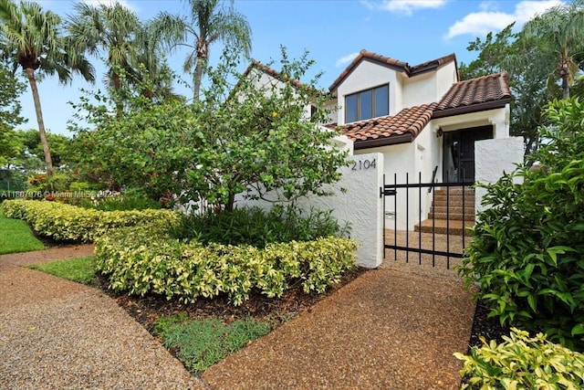7932 Seville Pl Unit 2104, Boca Raton, FL 33433 - mediterranean / spanish home with a tile roof, stucco siding, a fenced front yard, and a gate