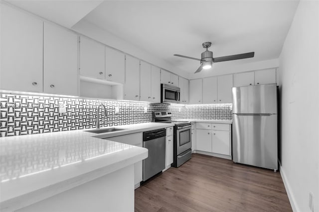 1051 Meridian Ave Unit 1-A, Miami Beach, FL 33139 - kitchen featuring stainless steel appliances, tasteful backsplash, white cabinets, and ceiling fan