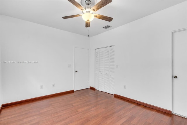 1051 Meridian Ave Unit 1-A, Miami Beach, FL 33139 - unfurnished bedroom featuring wood finished floors, baseboards, a closet, and a ceiling fan