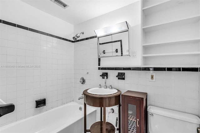 1051 Meridian Ave Unit 1-A, Miami Beach, FL 33139 - bathroom with toilet, shower / washtub combination, tile walls, and a sink