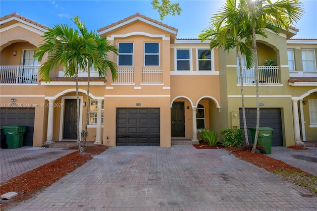 1470 SE 26th Ave, Homestead, FL 33035 - multi unit property featuring a balcony, stucco siding, an attached garage, driveway, and a tiled roof