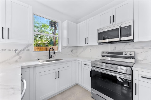 1470 SE 26th Ave, Homestead, FL 33035 - kitchen featuring appliances with stainless steel finishes, a sink, tasteful backsplash, and white cabinets