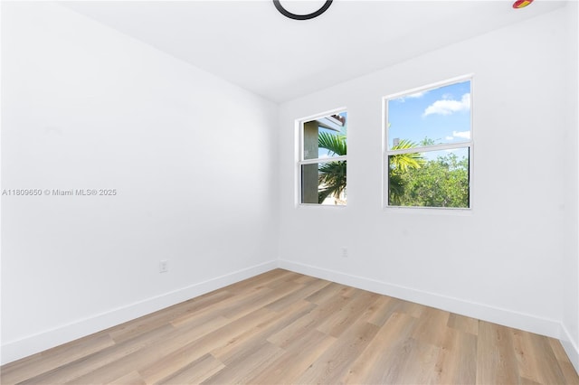 1470 SE 26th Ave, Homestead, FL 33035 - empty room with light wood-style floors and baseboards