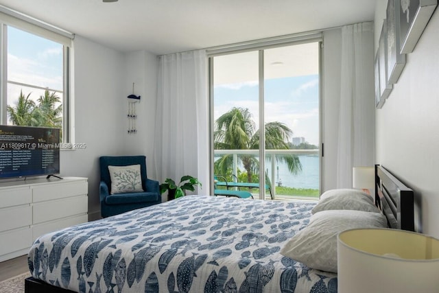 17050 N Bay Rd Unit 401, Sunny Isles Beach, FL 33160 - bedroom featuring access to exterior, a water view, floor to ceiling windows, and wood finished floors