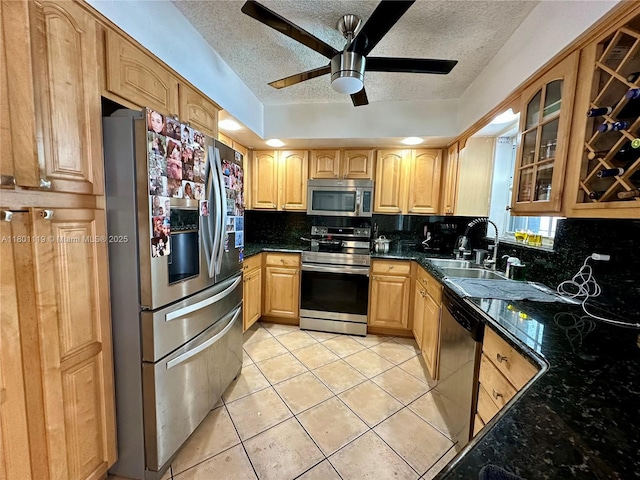 21000 NE 26th Ave, Miami, FL 33180 - kitchen with appliances with stainless steel finishes, a textured ceiling, a ceiling fan, glass insert cabinets, and decorative backsplash