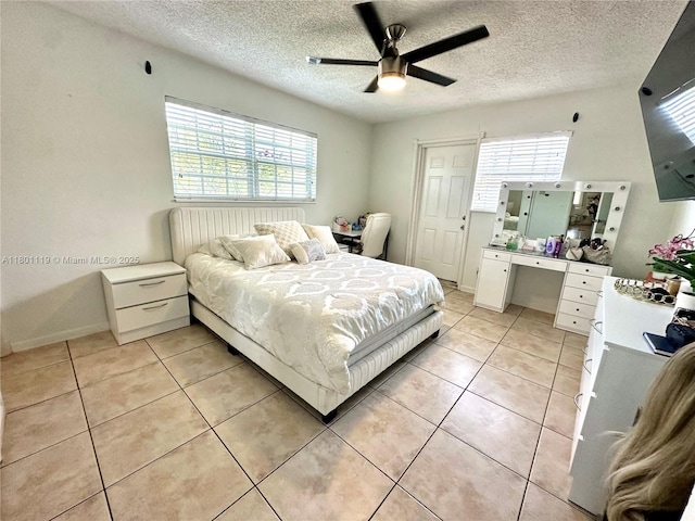 21000 NE 26th Ave, Miami, FL 33180 - bedroom with multiple windows, light tile patterned flooring, a textured ceiling, and ceiling fan