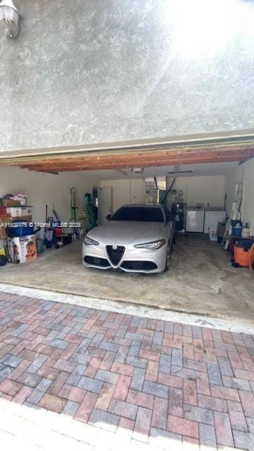 21080 SW 242nd St, Homestead, FL 33031 - garage featuring decorative driveway and washer / dryer