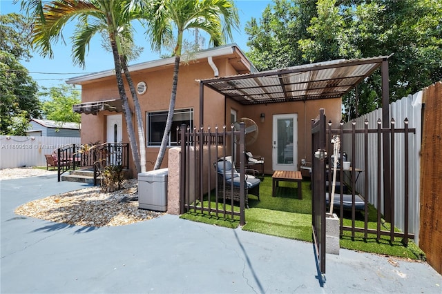 37 NW 47th Ter, Miami, FL 33127 - view of front of house with stucco siding and a patio area