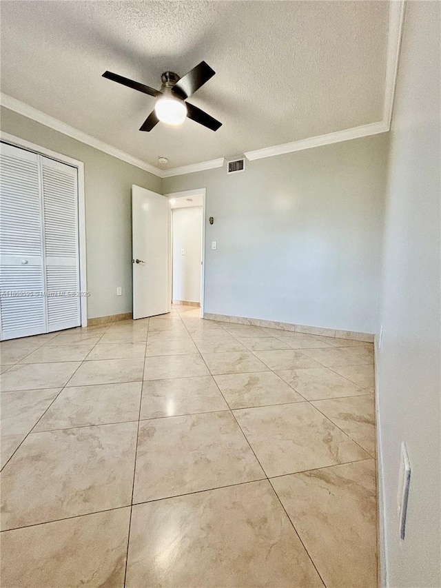 3536 NE 168th St Unit 201, North Miami Beach, FL 33160 - unfurnished bedroom with ornamental molding, a textured ceiling, a ceiling fan, and baseboards