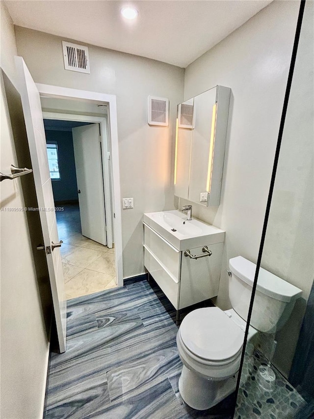 3536 NE 168th St Unit 201, North Miami Beach, FL 33160 - bathroom featuring toilet, vanity, and recessed lighting