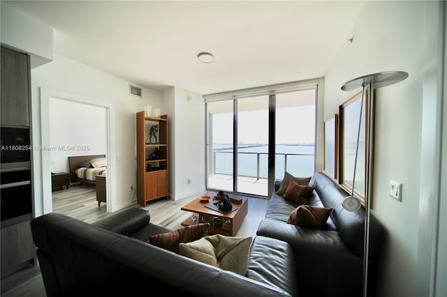 2900 NE 7th Ave Unit 2105, Miami, FL 33137 - living room featuring wood finished floors, a water view, and baseboards