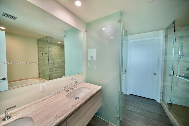2900 NE 7th Ave Unit 2105, Miami, FL 33137 - bathroom with a stall shower, double vanity, wood finished floors, a bath, and recessed lighting