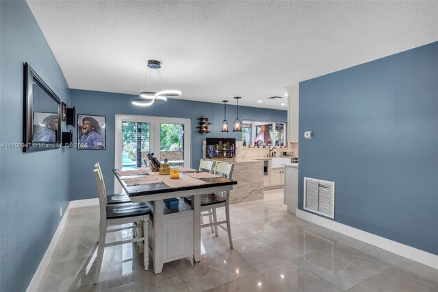 641 SW 50th Ave, Margate, FL 33068 - dining room featuring a chandelier, baseboards, and a textured ceiling