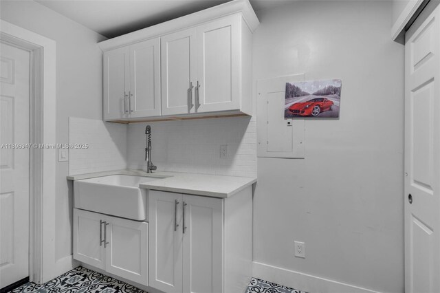641 SW 50th Ave, Margate, FL 33068 - laundry area featuring a sink, tile patterned floors, and baseboards