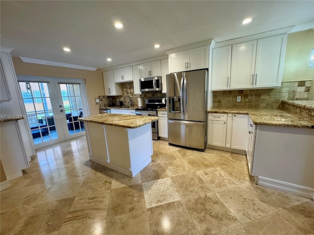 2200 Monroe St Unit 33, Hollywood, FL 33020 - kitchen with appliances with stainless steel finishes, ornamental molding, a sink, french doors, and backsplash
