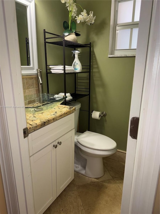 2200 Monroe St Unit 33, Hollywood, FL 33020 - half bath with vanity, toilet, tile patterned floors, decorative backsplash, and baseboards