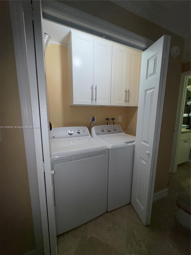 2200 Monroe St Unit 33, Hollywood, FL 33020 - laundry area with cabinet space, washer and dryer, and light tile patterned flooring