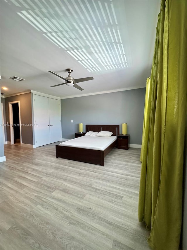2200 Monroe St Unit 33, Hollywood, FL 33020 - bedroom with crown molding, baseboards, light wood-style flooring, and a ceiling fan