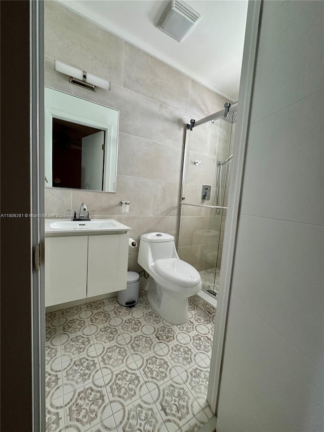 2200 Monroe St Unit 33, Hollywood, FL 33020 - full bathroom with tile walls, a shower stall, toilet, vanity, and tile patterned flooring