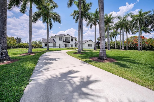 5121 SW 210th Ter, Southwest Ranches, FL 33332 - view of front of house with a front yard, stucco siding, and driveway